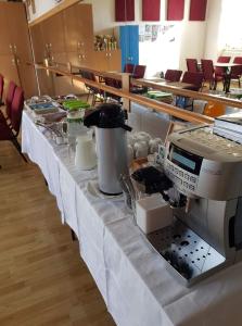 a table with a coffee maker on top of it at Apartmany Kanianka in Bojnice