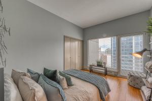 a bedroom with a large bed and a large window at Newmark Tower in Seattle