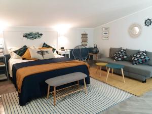 a bedroom with a bed and a couch at IL CUCCO B&B in Ginosa Marina