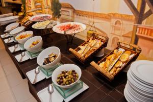 a buffet with many different types of food on a table at Blue Tree Premium Faria Lima in São Paulo +66 photos