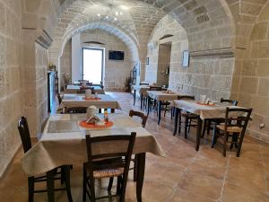a restaurant with tables and chairs in a room at Villa Papaleo B&B in Bagnolo del Salento