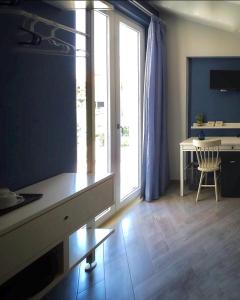 a room with a desk and a table and a window at IL CUCCO B&B in Ginosa Marina