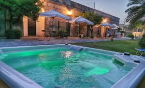 a pool with green water in a backyard at Villa Papaleo B&B in Bagnolo del Salento