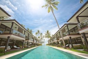 a large swimming pool in front of a large building at Nikki Beach Resort & Spa Koh Samui - SHA Extra Plus in Lipa Noi