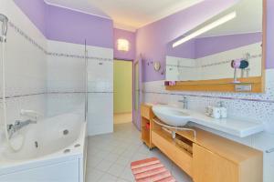 a bathroom with a tub and a sink and a shower at Villa Giardina Apartments in Vinkuran +37 photos