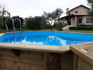 a pool with a wooden deck and a swimming pool with a pool at L'Orto sul Poggio in Sutri