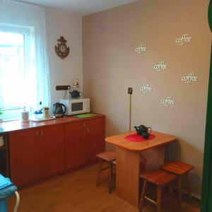 a kitchen with a table and a microwave at Promyk in Władysławowo