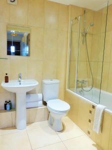 a bathroom with a toilet and a sink and a shower at Monks Retreat in York