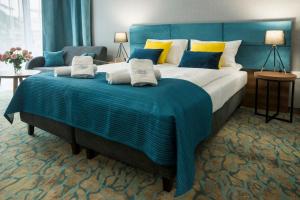 Łóżko lub łóżka w pokoju w obiekcie STELLA Resort & SPA