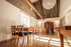 a dining room with a wooden table and chairs at Traube Blansingen in Efringen-Kirchen