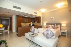 a living room with a bed and a couch at Prime Retreats - Downtown Dubai in Dubai