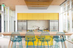 a kitchen with yellow and blue chairs and a table at Mayumi in Los Angeles
