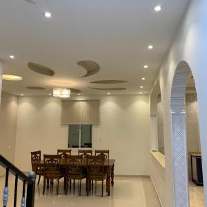 a dining room with a table and chairs at Al Taif Villas in Taif