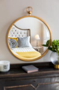 a bedroom with a bed and a mirror on a dresser at Superior Stays Luxury Apartments - Bath City Centre in Bath