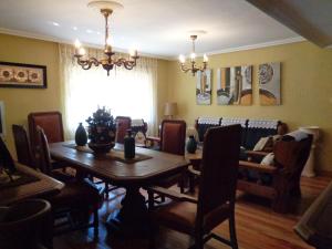 a dining room with a wooden table and chairs at Apartamento Casa Geli # 2 in Onís