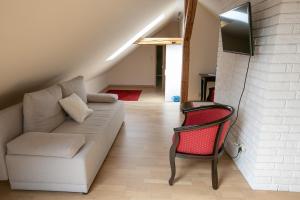 a living room with a couch and a chair at Mazurski Dwór in Olecko