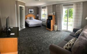 a hotel room with a bed and a couch at Marine Village Resort in Lake George