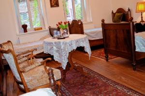 a room with a table and two beds at Penzion u Čermáka in Ostrov