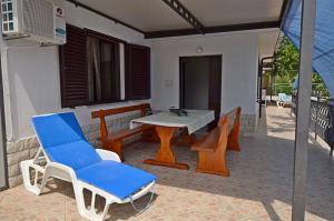 a patio with a table and chairs and a table and chairs at Apartments Elza in Opric