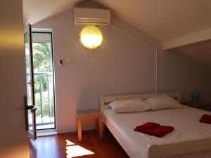 a bedroom with a bed with a light on the wall at Holiday House ''Villa Flora'' in Šibenik +56 photos