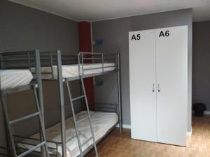 a room with two bunk beds and a door at galerna aterpetxea in Zarautz