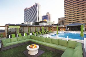 a rooftop patio with a couch and a fire pit at Tropicana Atlantic City, A Caesars Destination in Atlantic City