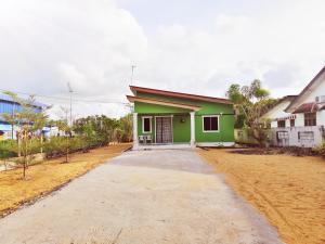 a green and white house with a driveway at Homestay Bandar Pekan - musleem preferred in Pekan