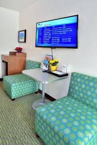 a waiting room with a table and chairs and a tv at Old Town Inn in San Diego