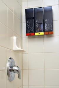 a bathroom with two books on a tiled wall at Old Town Inn in San Diego