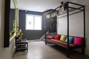 a room with a bunk bed with colorful pillows at Four Sisters Homestay in Bangkok