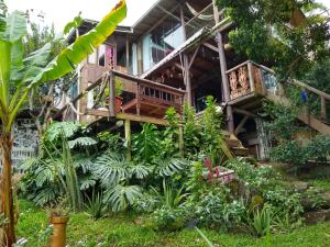 a house with a balcony and plants in front of it at Hostel do Morro in Florianópolis