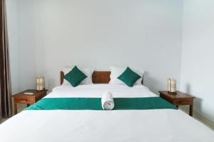 Ein Bett oder Betten in einem Zimmer der Unterkunft Canggu Nadi Guest House