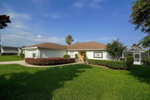 a house with a green lawn in front of it at Luxury 2BR-3BA Pool Villa and 20 Min to WEC- Ocala in Inverness