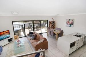 a living room with a couch and a table at Cypress Townhouse 17 - Mulwala in Mulwala