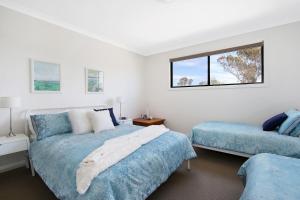 a bedroom with two beds and a window at Cypress Townhouse 17 - Mulwala in Mulwala