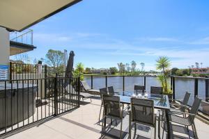 a patio with a table and chairs overlooking the water at Cypress Townhouse 17 - Mulwala in Mulwala
