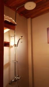 a shower stall in a bathroom with a ceiling at Free Beach Resort in Phú Quốc