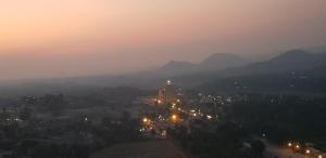 a view of a city at night with lights at Padmaa Hampi Villa in Hampi