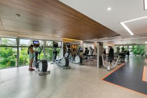 a gym with people exercising on tread machines at Scenic Valley Marvel in Ho Chi Minh City