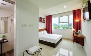 a hotel room with a bed and a window at V Hotel Kuala Lumpur in Kuala Lumpur