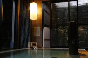 a house with a swimming pool in front of a window at Onyado Nono Nara Natural Hot Spring in Nara