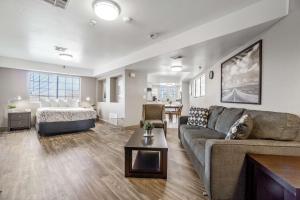 a living room with a couch and a bed at Rancho San Diego Inn & Suites in El Cajon