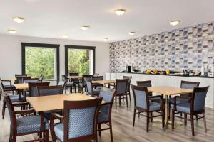 a restaurant with tables and chairs and a counter at Travelodge by Wyndham Rigaud in Rigaud