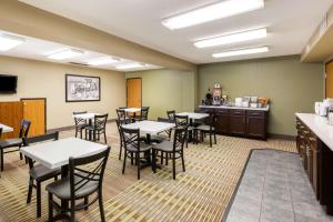 a restaurant with tables and chairs in a room at Super 8 by Wyndham Storm Lake in Storm Lake