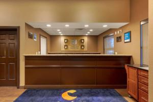 a lobby with a reception desk in a building at Comfort Inn & Suites Fayetteville-University Area in Fayetteville