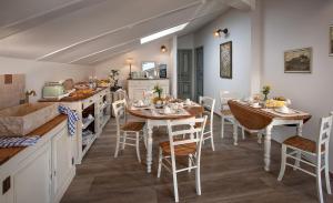 a kitchen and dining room with tables and chairs at Roncaglia Suite in Monticello d'Alba
