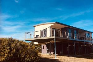 a house on the beach with scaffolding around it at Freycinet Dream in Coles Bay