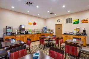 a restaurant with tables and chairs and a counter at Quality Inn I-70 Near Kansas Speedway in Kansas City