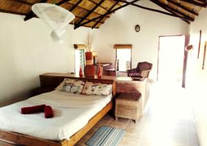 1 dormitorio con cama, escritorio y silla en Barefoot Lodge and Safaris - Malawi en Lilongüe