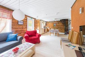- un salon avec un canapé et un fauteuil rouge dans l'établissement Toolse Puhkeküla, à Toolse